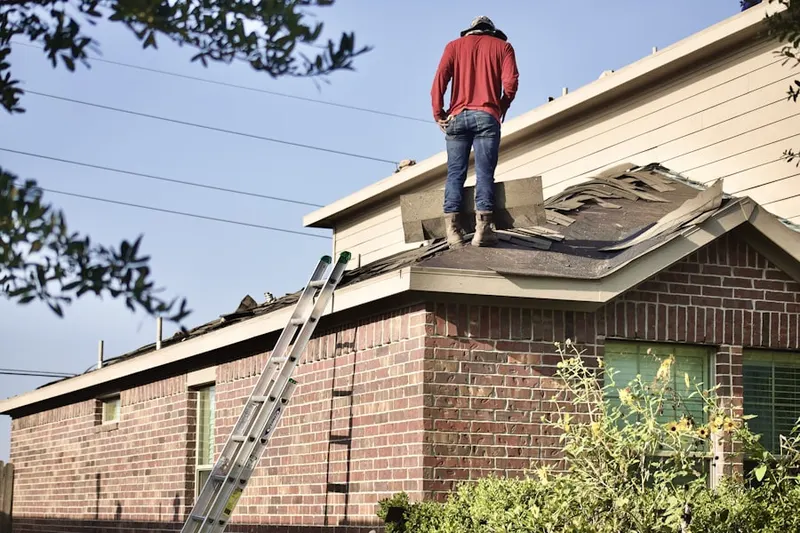 Professional roofer working on a residential roof in Socastee